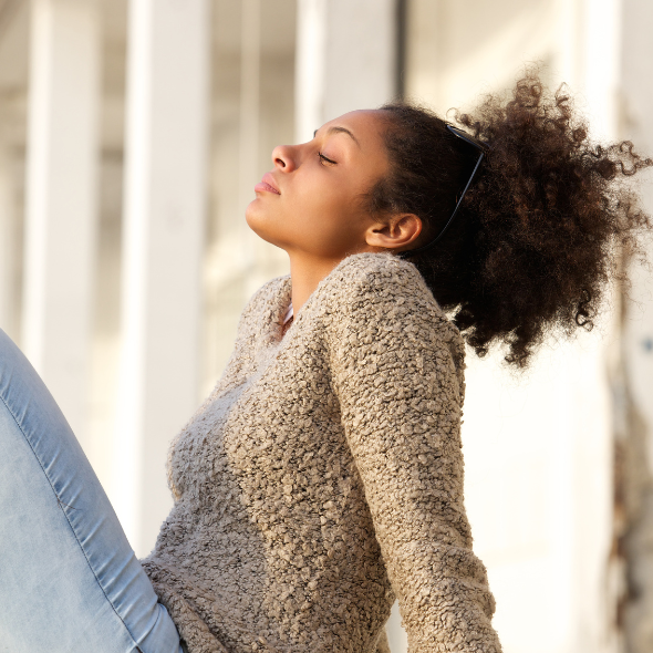 Woman with PCOS tilts head back with eyes closed